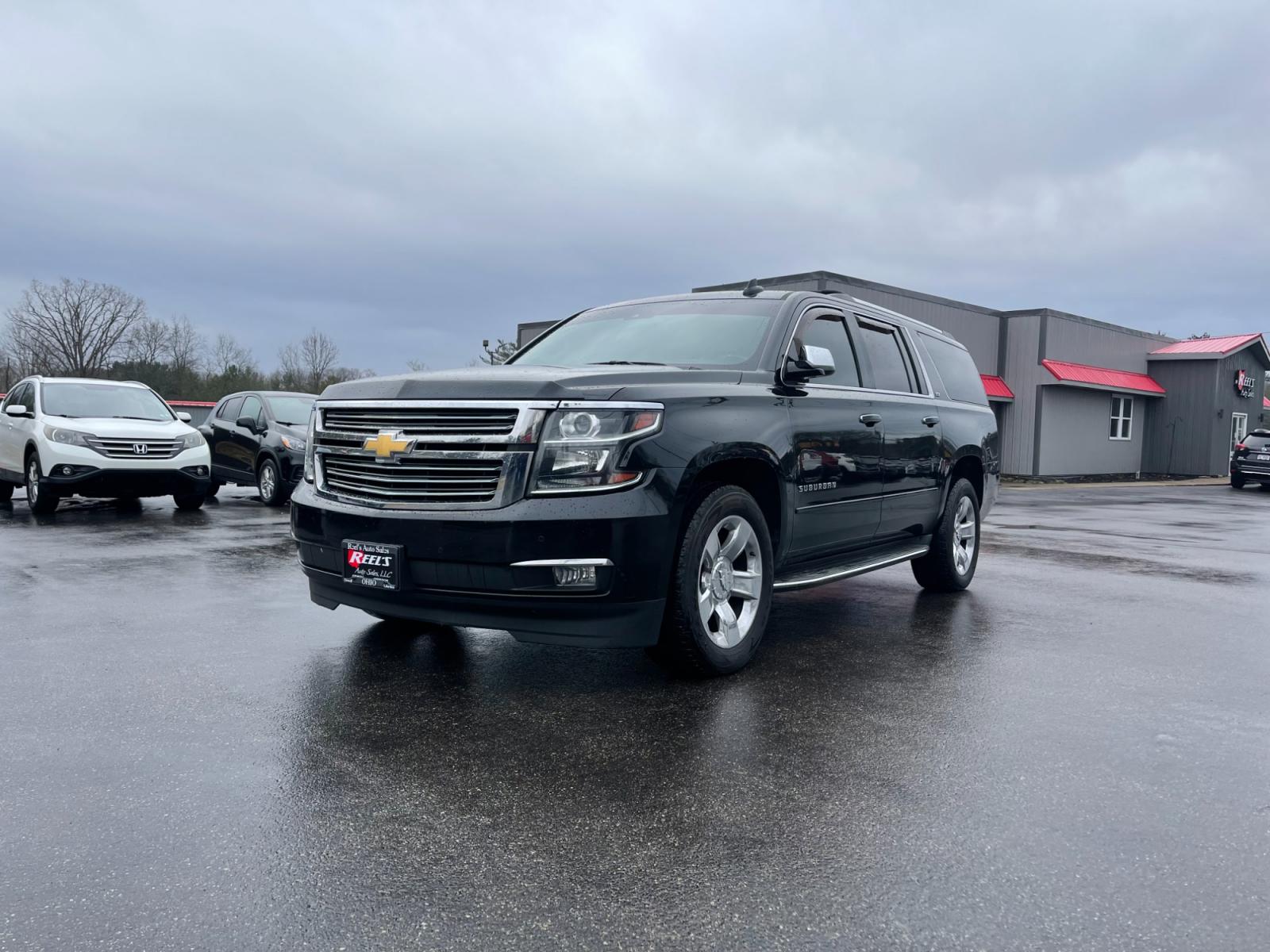 2016 Black /Brown Chevrolet Suburban LTZ 4WD (1GNSKJKC3GR) with an 5.3L V8 OHV 16V engine, 6A transmission, located at 11115 Chardon Rd. , Chardon, OH, 44024, (440) 214-9705, 41.580246, -81.241943 - This 2016 Chevrolet Suburban LTZ 4WD comes equipped with a 5.3 Vortec V8 engine and a 6-speed automatic transmission, offering a robust 8,000-pound towing capacity. It's designed with luxury and convenience in mind, featuring heated and cooled front seats, heated second-row seats, and a range of saf - Photo #0